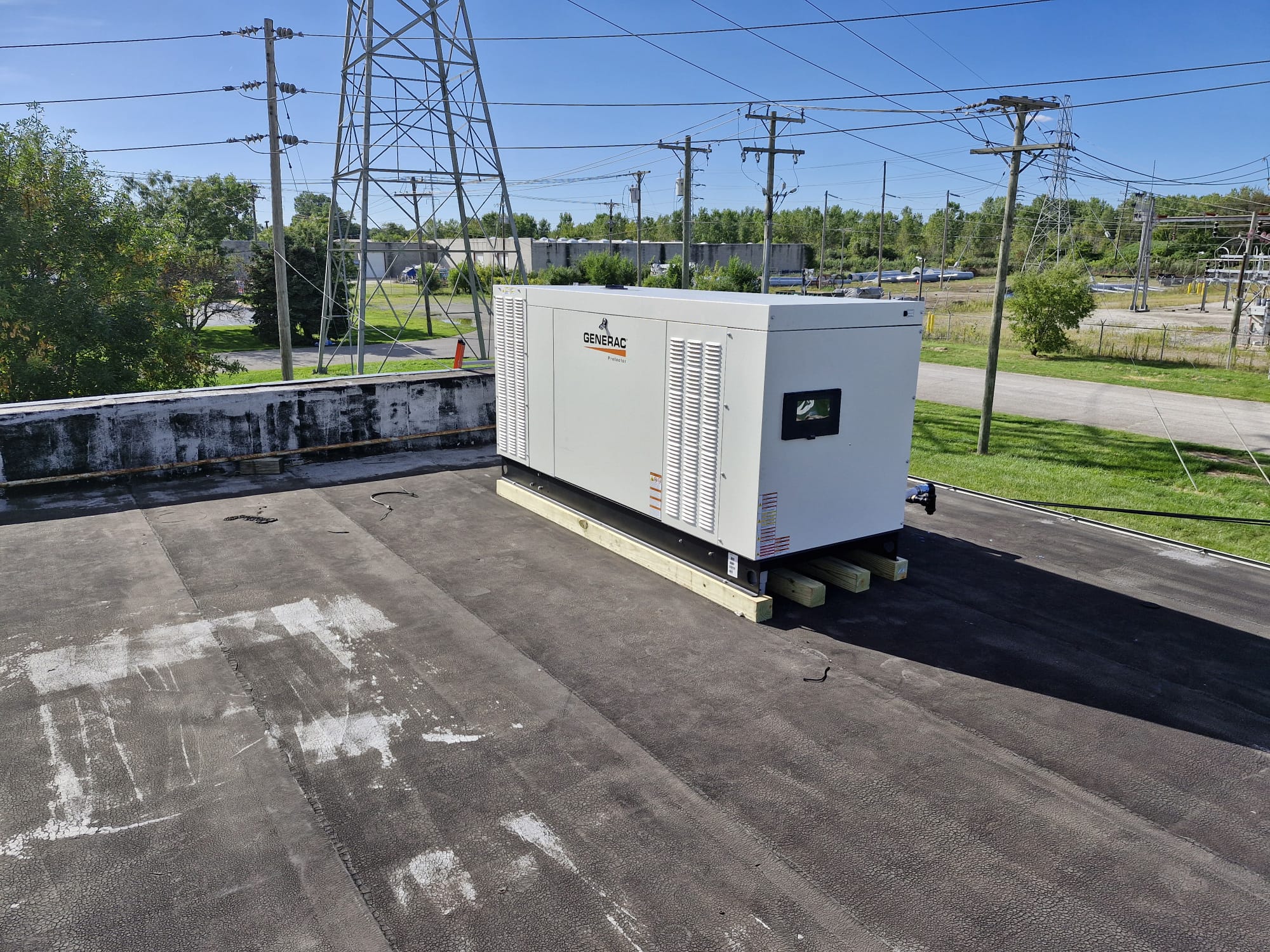 Rooftop standby generator on wood base